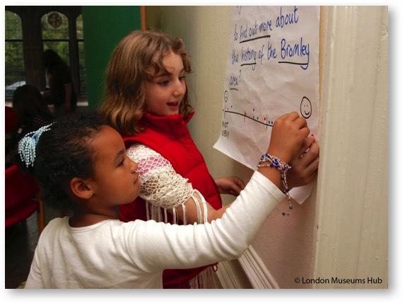 childeren writing on evaluation chart